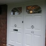 Double entrance door with custom arched windows
