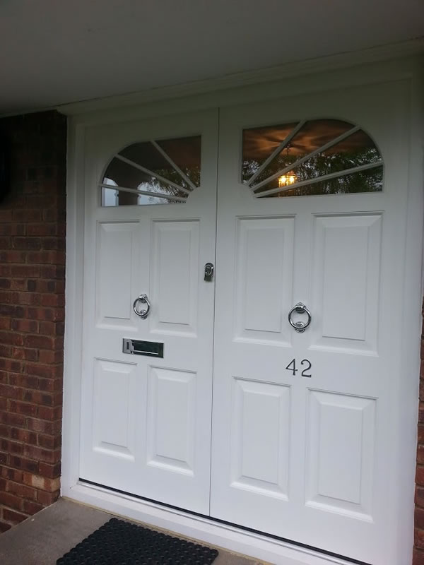 Double entrance door with custom arched windows