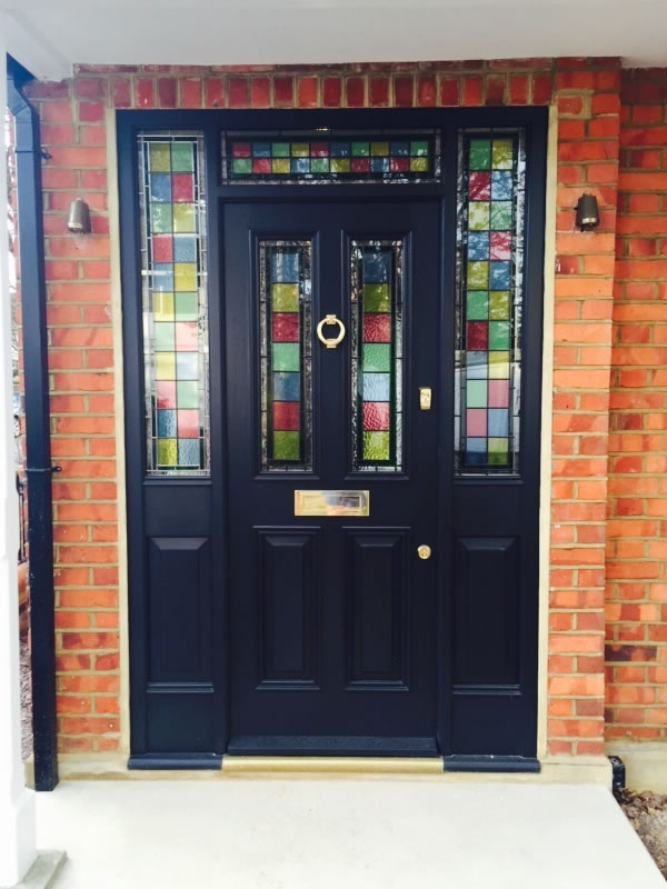 Black entrance door with stained decorative glass