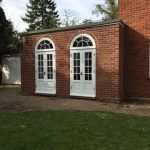 French doors with curved window above