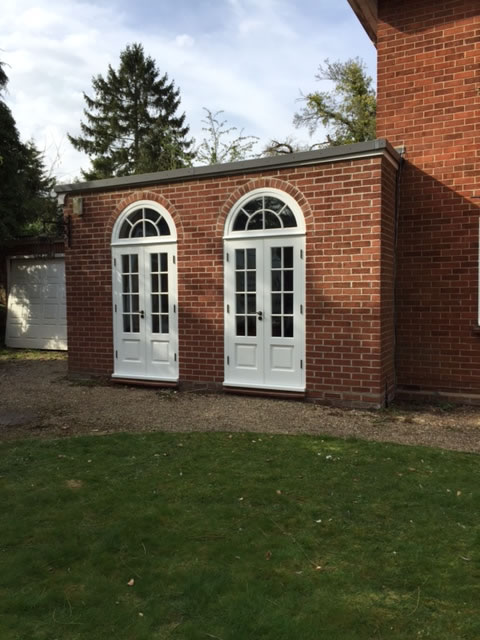 French doors with curved window above