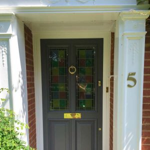 Painted timber front door with stained glass panels