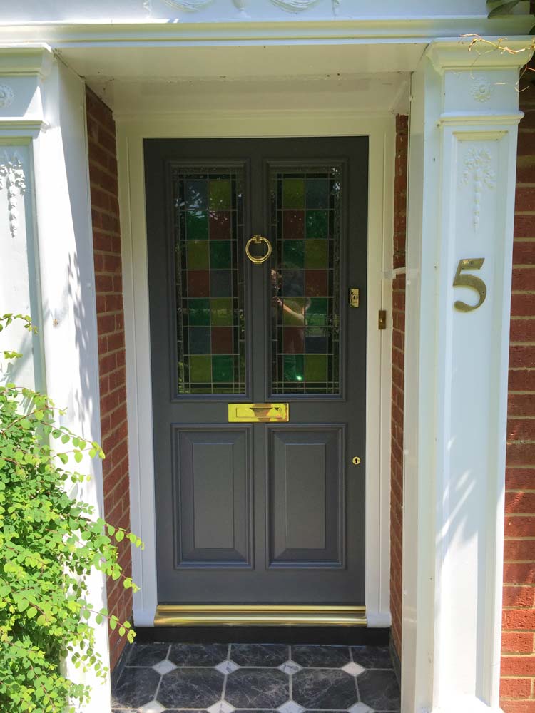 Painted timber front door with stained glass panels