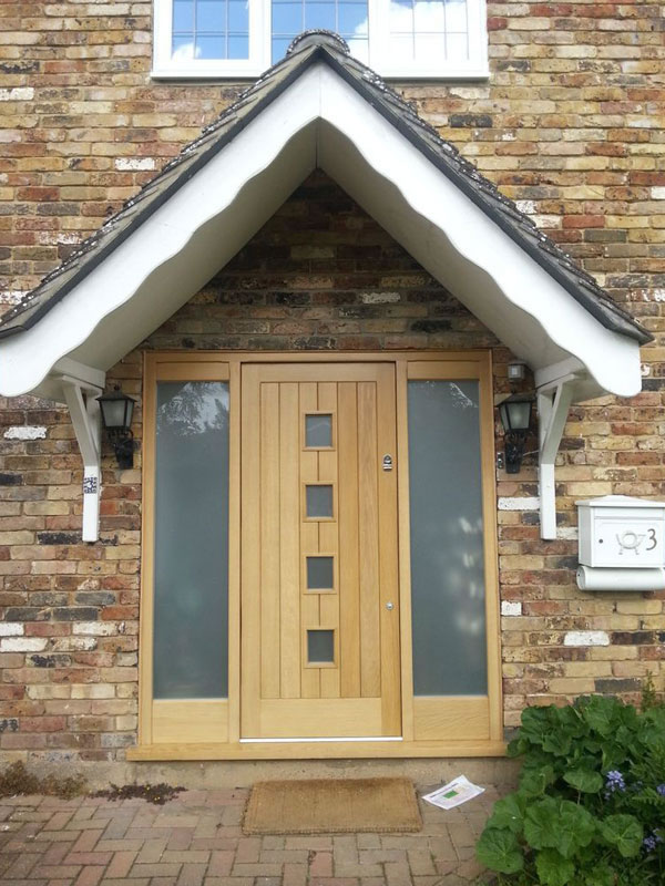Timber front door with sidelights and glazed sections