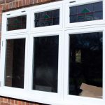 Timber casement windows with lead details and coloured glass pattern