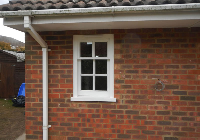 Small wooden sash window painted white
