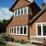 Wooden windows painted white on large house