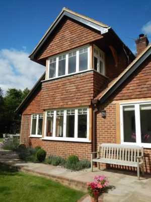 Timber windows painted white on large house