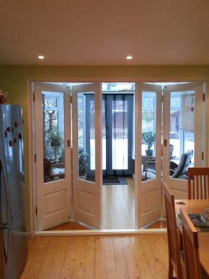 Folding timber bi-fold door painted white