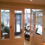 Timber bi-folding door partially open