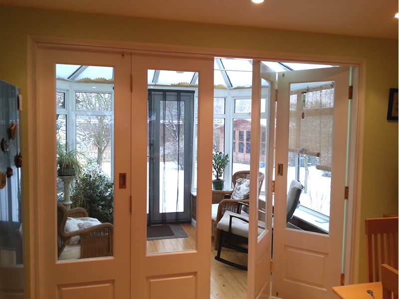 Timber bi-folding door partially open